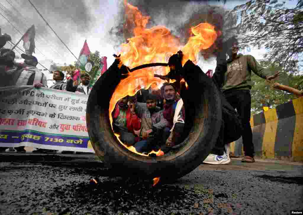 Activists from Jan Adhikar Party burn tires as they block a road during a strike called by student associations to protest what they call irregularities in recruitment by the railways department, in Patna, Bihar, India.