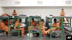 Inmates hang out on their bunks in the Harris County Jail in Houston, Texas.