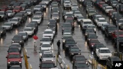 FILE -Cars wait to enter the United States from Tijuana, Mexico through the San Ysidro port of entry in San Diego, Dec. 25, 2014.