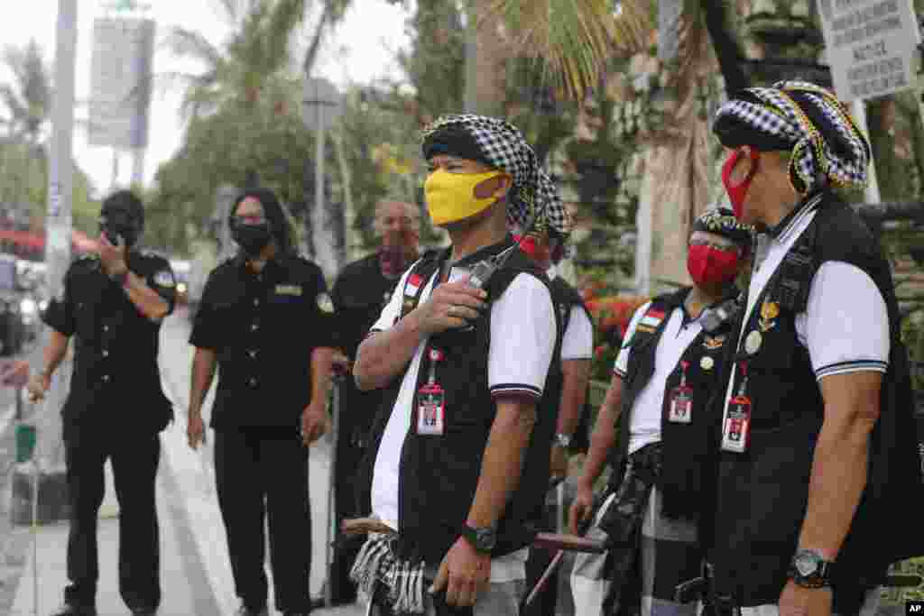 Traditional guards called &#39;pecalang&#39; guard the access to Kuta Beach, a famous spot normally crowded with tourists on New Year&#39;s Eve, on the resort island of Bali, Indonesia.&nbsp;The government banned New Year&#39;s celebrations that could attract crowds in order to prevent the spread of the new coronavirus.&nbsp;