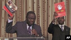 FILE: Former Zimbabwe Prime Minister and Movement For Democratic Change (MDC) leader Morgan Tsvangirai (L) and then National Organising Secretary Nelson Chamisa present a booklet at the launch of Conditions for a Sustainable Election in Zimbabwe (COSEZ) in Harare, March 8