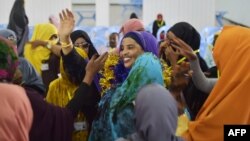 A handout picture released by the African Union-United Nations Information Support Team, shows Yurub Ahmed Raabi, the winner of a seat in the Somalia's parliament (House of the People), celebrating with delegates who voted for heat a polling station in Mogadishu, Somalia, Dec. 6, 2016.