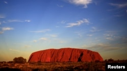 FILE: Uluru is lit by the setting sun in the Northern Territory in central Australia, April 21, 2014. 