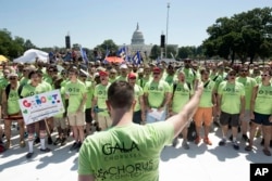 The Gay and Lesbian Association of Choruses (GALA) members from around the country sing on the National Mall with Capitol Hill in the background, during the Equality March for Unity and Pride in Washington, June 11, 2017.