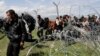 Police Fire Tear Gas at Migrants on Macedonian-Greek Border 