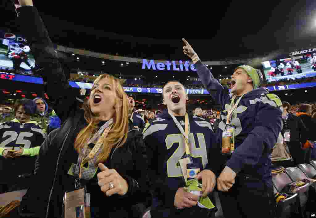 Seattle Seahawks fans cheer before the NFL Super Bowl XLVIII football game between the Seattle Seahawks and the Denver Broncos, Feb. 2, 2014, in East Rutherford, N.J.