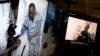 Video clips show China's jailed Nobel Peace laureate Liu Xiaobo lying on a bed receiving medical treatment at a hospital, left, and Liu saying wardens take good care of him, on a computer screens in Beijing, June 29, 2017.