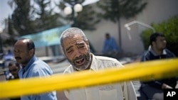 A Libyan man weeping outside Hikma hospital in Misrata, Libya. The port of a besieged rebel-held city in western Libya was quiet Wednesday after fierce bombardment and attack the day before by government forces. It is unknown why the man is weeping, April