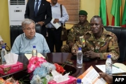 FILE - U.N. Secretary-General Antonio Guterres, left, meets with Malian Army General Didier Dacko, Force Commander of the G5 Sahel, in Mali, May 29, 2018.