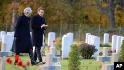 British Prime Minister Theresa May and French President Emmanuel Macron visit the Thiepval cemetery as part of ceremonies to mark the centenary of the 1918 Armistice, in Thiepval, northern France, Nov. 9, 2018. 