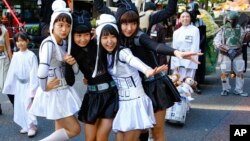 Star Wars fans dressed in costumes of Star Wars characters pose for a photo during a Halloween parade in Kawasaki, near Tokyo, Oct. 25, 2015.