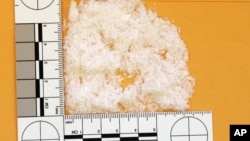 A quantity of crystal methamphetamine totaling 6.4 grams is displayed next to a ruler (File photo).