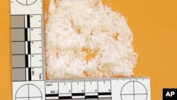 FILE - A quantity of methamphetamine totaling 6.4 grams is displayed next to a ruler.