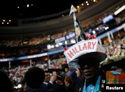 A delegate wears a hat decorated in support of Democratic U.S. presidential nominee Hillary Clinton on the final night of the Democratic National Convention in Philadelphia, July 28, 2016.