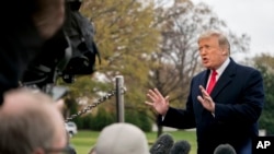 President Donald Trump speaks to members of the media before boarding Marine One on the South Lawn of the White House in Washington, Nov. 26, 2018.