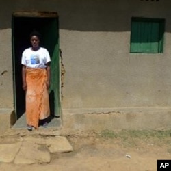 Jaqueline Mukamana, a genocide survivor, stands outside her home