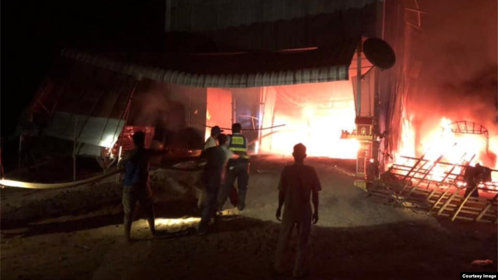 Firefighters put out a fire after Nun Sareth's house was engulfed in flames in Boribo district, Kampong Chhnang province, Cambodia, on May 9, 2021. (Courtesy of Child Protection Unit)