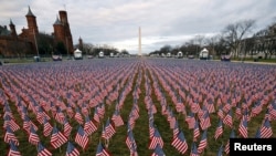 Thousands of U.S. flags are seen January 18, 2021, at the National Mall, as part of a memorial paying tribute to the U.S. citizens who have died from COVID-19, near the Capitol ahead of President-elect Joe Biden's inauguration, in Washington, D.C.