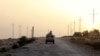 FILE - An Egyptian military vehicle is seen on a highway in northern Sinai, Egypt, May 25, 2015. The United States on July 26, 2018, released $195 million in military aid to Egypt that had been withheld over allegations of human rights violations by Egypt's government.