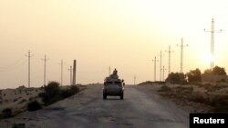 FILE - An Egyptian military vehicle is seen on a highway in northern Sinai, Egypt, May 25, 2015. Egypt has been battling an insurgency in northern Sinai that has been led by an Islamic State affiliate since 2014.