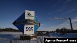 Signage for the Listvyazhnaya coal mine is seen on the side of a road near the town of Belovo, in Russia's Kemerovo region, Nov. 26, 2021. Reports of a fire at the nearby Anatoly Ruban mine prompted the evacuation of dozens of miners Sunday. 