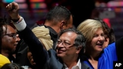 Former rebel Gustavo Petro and his wife Veronica Alcocer celebrate before supporters after winning a runoff presidential election in Bogota, Colombia, June 19, 2022.