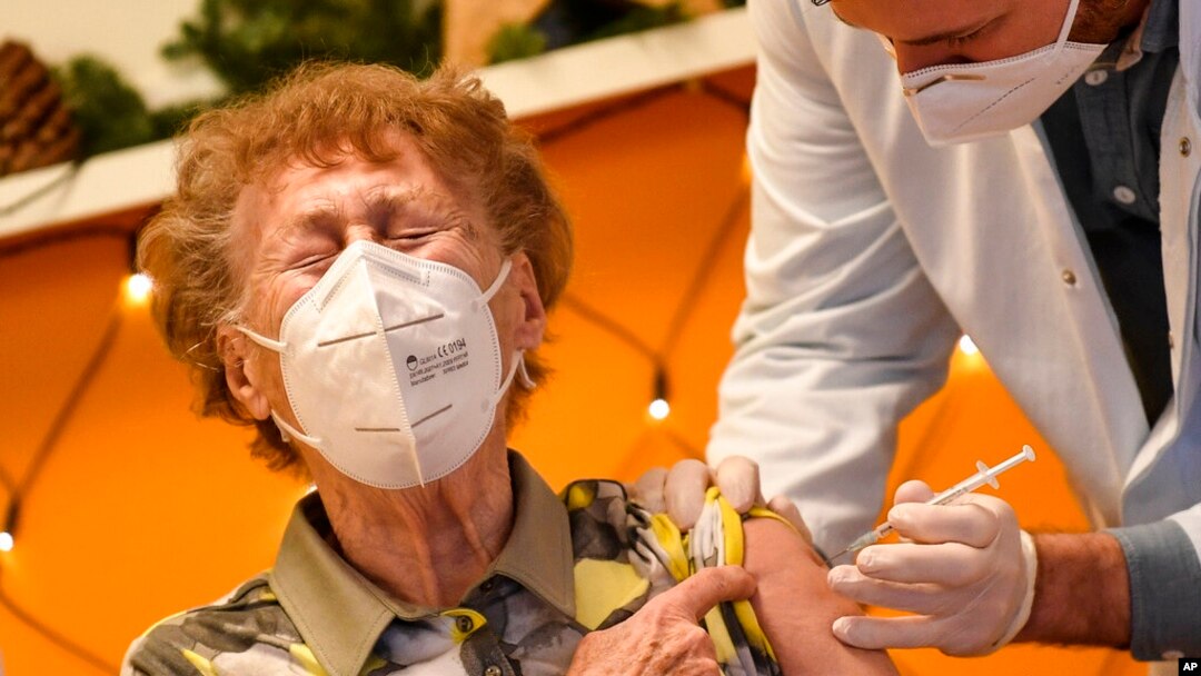 FILE - A resident of a nursing home reacts as she gets an injection of the COVID-19 vaccine in Cologne, Germany, Dec. 27, 2020. 