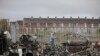 A man walks past a burnt out bus on the Shankill road in West Belfast, Northern Ireland. Authorities sought to restore calm after Protestant and Catholic youths in Belfast hurled bricks, fireworks and gasoline bombs at police and each other.&nbsp;