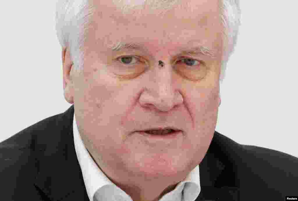 A fly is seen on German Interior Minister Horst Seehofer&#39;s face as he speaks during a joint news conference with Austrian Interior Minister Karl Nehammer (not pictured) in Vienna, Austria.