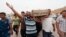 Relatives carry the coffin of an Iraqi police officer killed by militants during a funeral in Najaf, May 20, 2013.