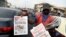 A roadside vendor holds a newspaper announcing the appointment of Ngozi Okonjo-Iweala as WTO Secretary-General in Ibadan, southwest of Nigeria, Feb. 16, 2021. 