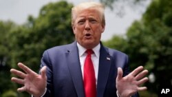 President Donald Trump talks to reporters before departing the White House for a trip to Michigan, Thursday, May 21, 2020, in Washington. (AP Photo/Evan Vucci)