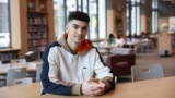 Max Decker, a senior at Lincoln High School, sits for a portrait in the school library where he often worked on writing his college essays, in Portland, Ore., Wednesday, March 20, 2024. (AP Photo/Amanda Loman)
