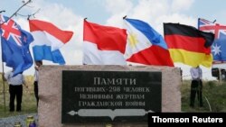 Relatives attend the revealing of the National Monument for the MH17 victims in Vijfhuizen, The Netherlands, July 17, 2017. 