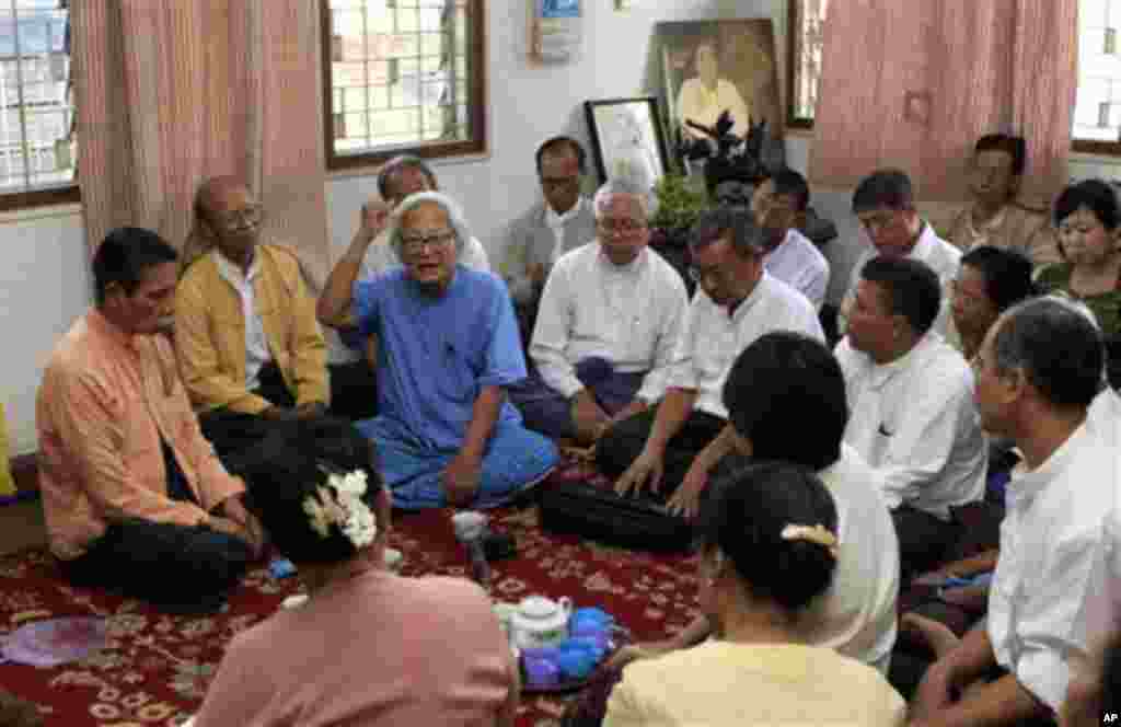 Win Tin, in blue, former senior leader of the detained opposition leader Aung San Suu Kyi's defunct National League for Democracy, delivers address during the 20th anniversary of last elections in which they won at home of their deputy leader Tin Oo, left