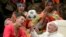 Pope Francis twirls a soccer ball presented to him by a member of the Circus of Cuba, during his weekly general audience in the Pope Paul VI hall, at the Vatican.