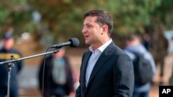 FILE - Ukrainian President Volodymyr Zelenskiy speaks to soldiers during his visit to military base outside Kyiv, Ukraine, Sept. 30, 2019.