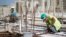 FILE - Palestinian laborers work at a construction site in Rawabi, near the West Bank city of Ramallah, Oct. 27, 2013.