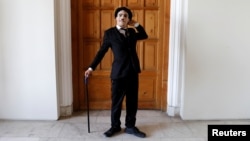 Afghanistan's Charlie Chaplin, Karim Asir, 25, reacts before his performance in Kabul, Afghanistan, Aug. 29, 2018. 