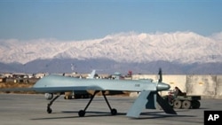 A US Predator unmanned drone armed with a missile sets off from its hangar at Bagram air base [file photo]