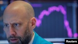 A trader works on the floor of the New York Stock Exchange, Feb 27, 2020. Wall Street's main indexes tumbled for a sixth straight session.