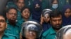 FILE - Journalists Shakil Ahmed, fifth from left, and Farzana Rupa, third from right, are pictured at a court in Dhaka, Aug. 22, 2024.