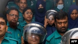 FILE - Journalists Shakil Ahmed, fifth from left, and Farzana Rupa, third from right, are pictured at a court in Dhaka, Aug. 22, 2024.