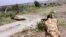 A ranger from the Kenya Wildlife Service shoots dead a male lion that had strayed from the Nairobi National Park, in Kajiado, Kenya, March 30, 2016. 
