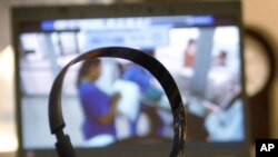 FILE - A doctor gets a headset ready before consulting via a video telemedicine hookup. Fraudulent use of telemedicine made up the bulk of the $6 billion in medical fraud schemes announced Wednesday by the U.S. Justice Department.