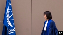 FILE - Judge Tomoko Akane walks before delivering a verdict at the International Criminal Court in The Hague, Netherlands, Nov. 20, 2024.