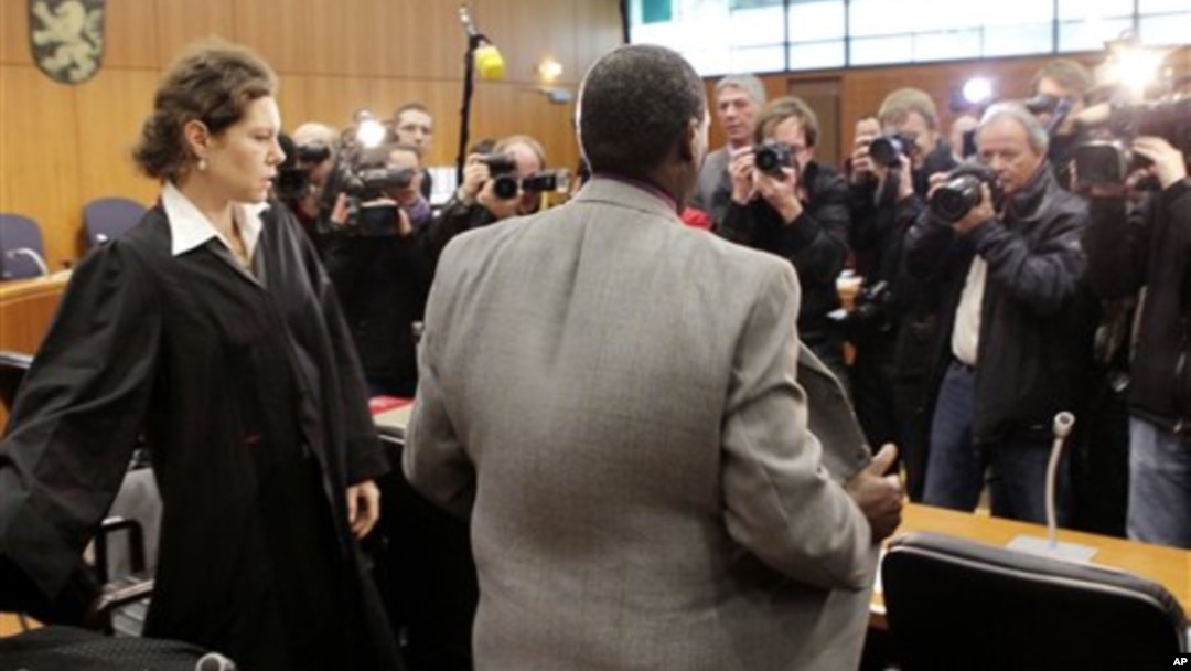 FILE - Onesphore Rwabukombe, 53, is photographed by media as he waits for the beginning of his trial at a court in Frankfurt, central Germany, Jan 18, 2011.