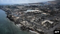 An aerial image taken on August 10, 2023 shows destroyed homes and buildings on the waterfront burned to the ground in Lahaina in the aftermath of wildfires in western Maui, Hawaii. (Photo by Patrick T. Fallon / AFP)