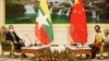 China's State Councillor and Foreign Minister Wang Yi is welcomed by and Myanmar's state counsellor Aung San Suu Kyi in Naypyitaw, Myanmar, Jan. 11, 2021.