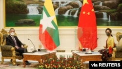 China's State Councillor and Foreign Minister Wang Yi is welcomed by and Myanmar's state counsellor Aung San Suu Kyi in Naypyitaw, Myanmar, Jan. 11, 2021.